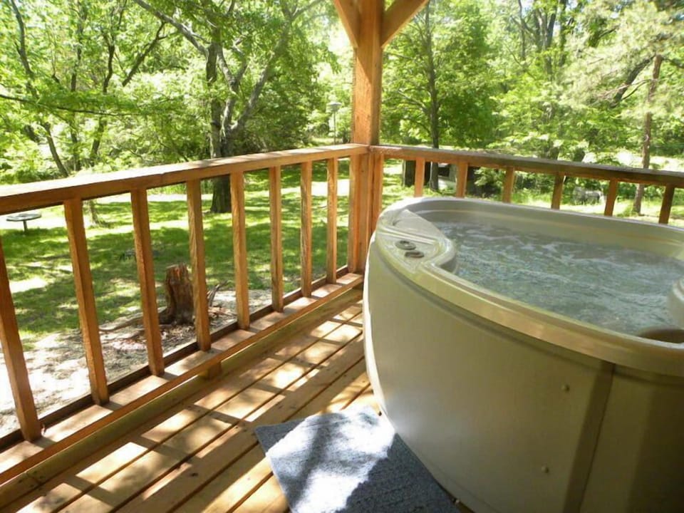 Outdoor Hot Tub to enjoy with the tree uplighting for extra ambiance