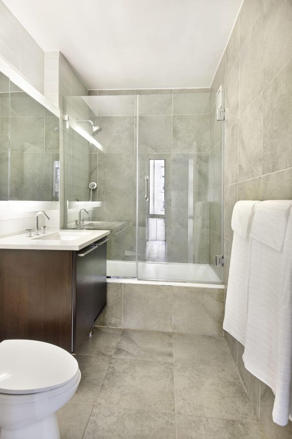 The bathroom has glass-enclosed shower, soak tub, glass tile & Kohler fixtures