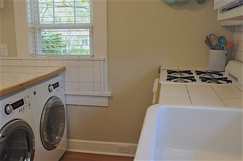 Studio  has its own washer and dryer tucked under the peninsula in the kitchen.