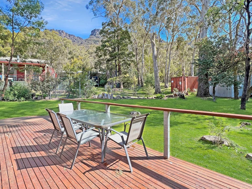 Cottage deck tranquility: Step into a charming outdoor retreat with fresh air and scenic views. 