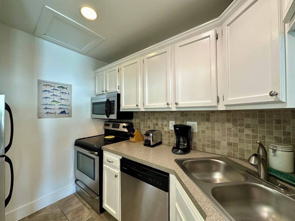 Your fully-equipped kitchen awaits with granite countertops, stainless appliances, and everything needed to prepare your favorite meals in comfort.