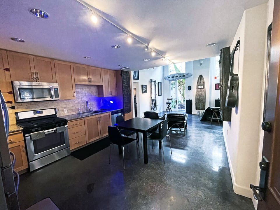 View from front door through kitchen and dining area to living room. 