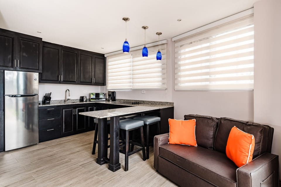 Fully equipped kitchen in studio apartment and twin sofa bed
