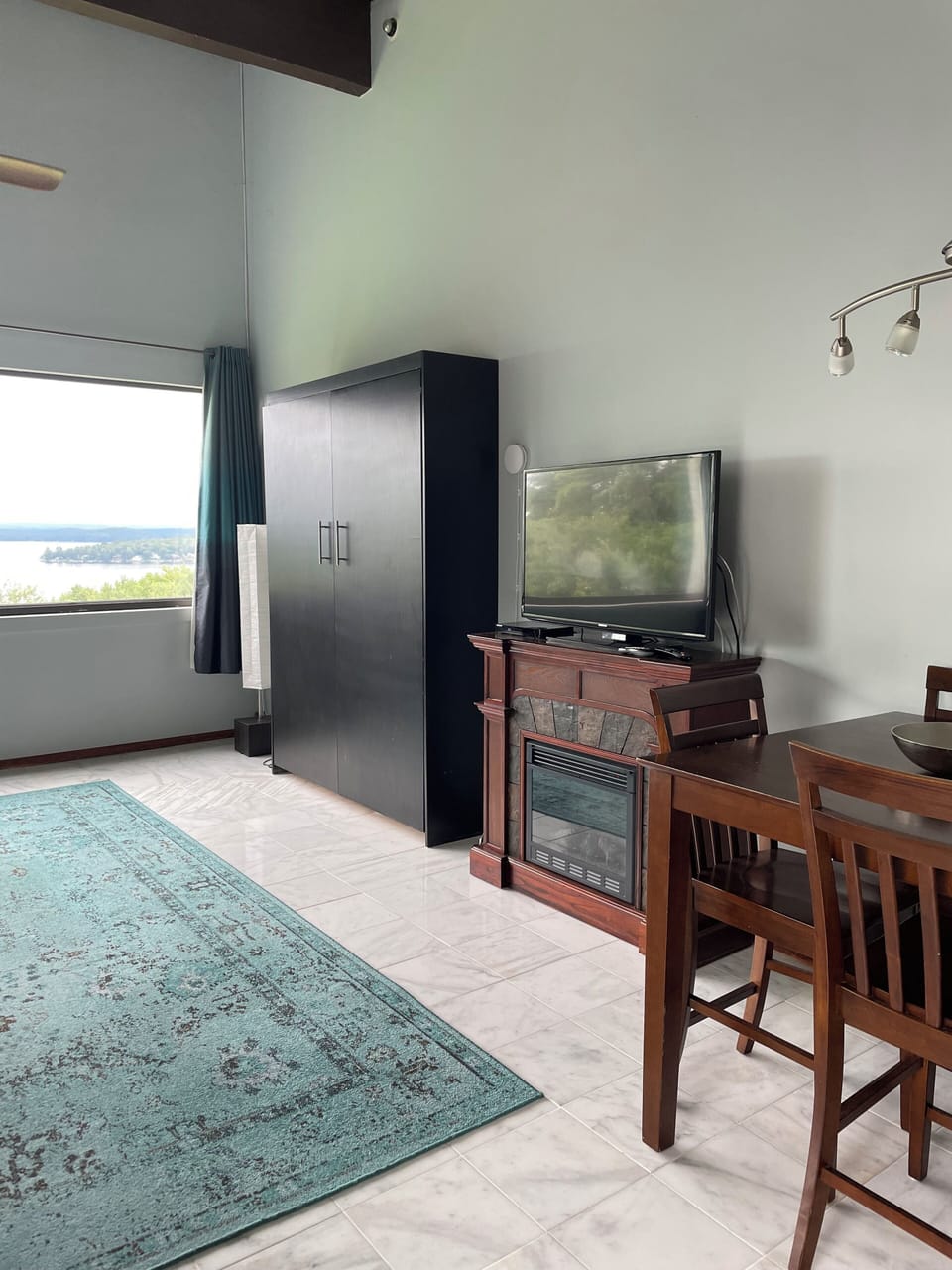 The living room has an electric fireplace with a 55"  Smart TV & a DVD player
