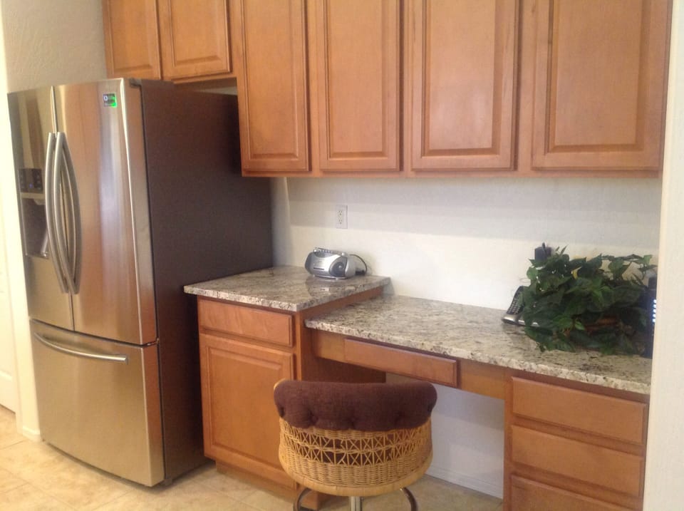 Desk area in kitchen area with WIFI and phone.