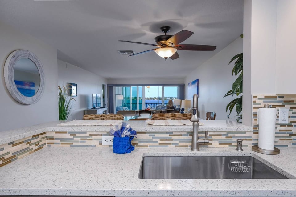Gorgeous renovated kitchen with stainless appliances and granite counters that's open to the main room