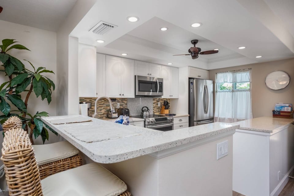 Stainless and solid stone kitchen stocked with pots, pans and dishes to prepare your favorite meals in-house.