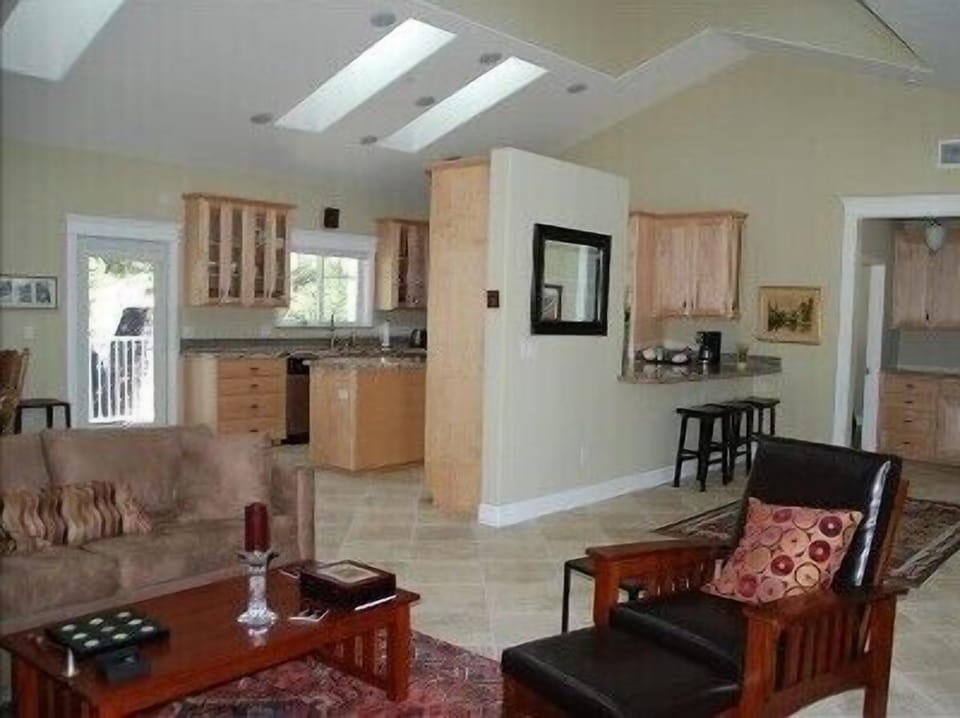 Open living area is light &amp; bright. High &amp; vaulted ceilings add to artsy flare