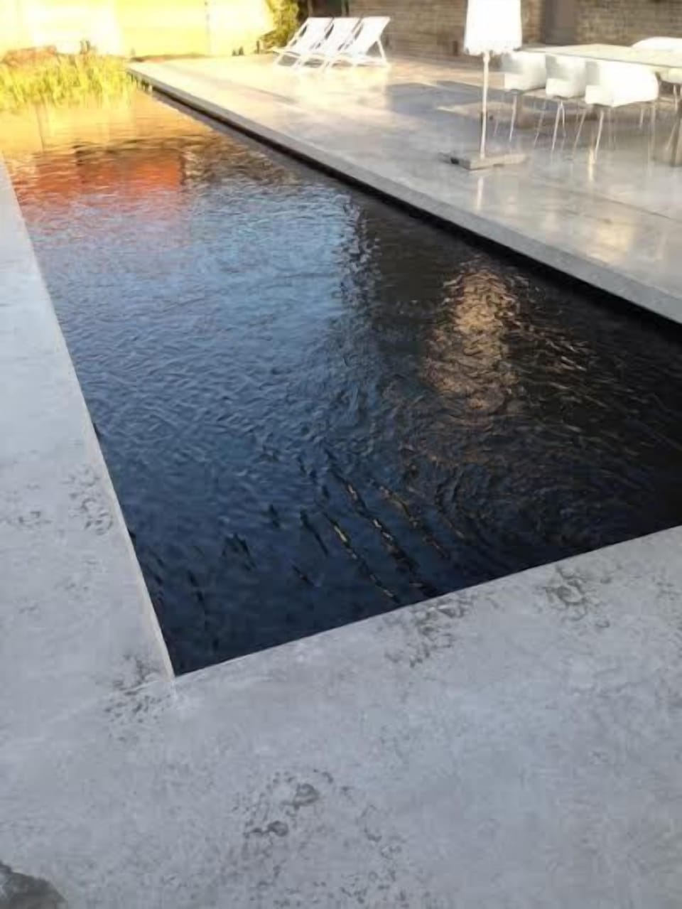 Large terrace with sunbeds and natural pool