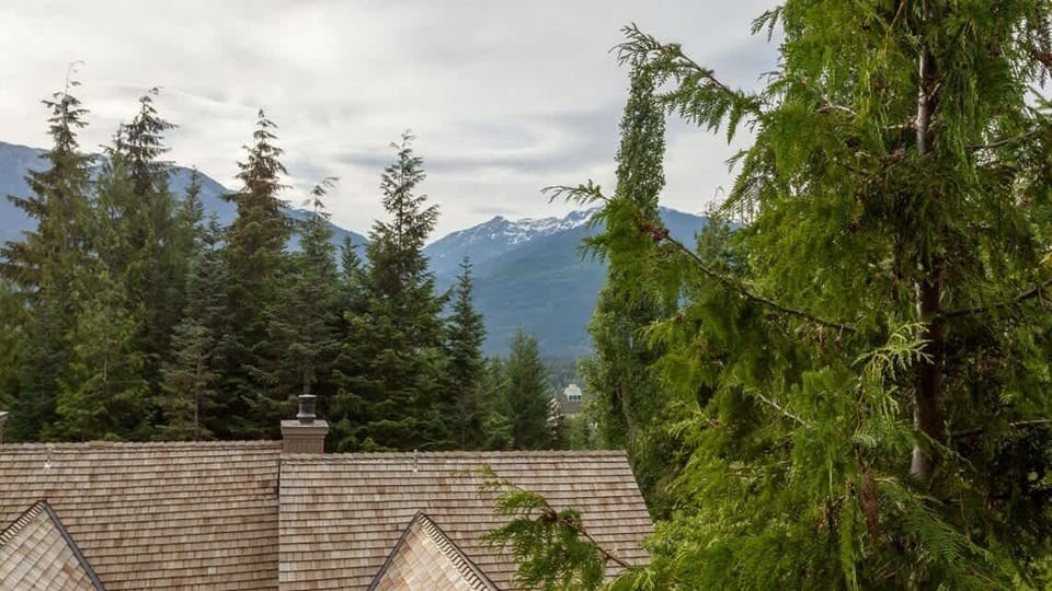 - Scenic mountain view framed by lush evergreens and rooftops  
- Enjoy serene moments surrounded by nature’s calm beauty  
- A peaceful outlook that captures the spirit of alpine living  