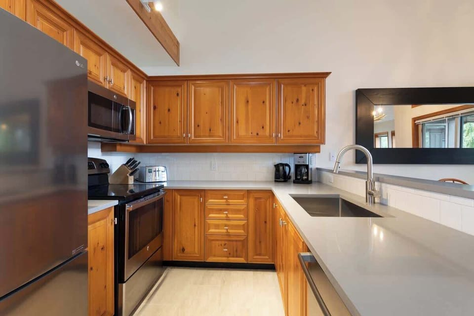 - Fully equipped kitchen with stainless steel appliances and natural wood cabinetry  
- Bright countertops and modern finishes make cooking easy and enjoyable for guests  
- Perfect for preparing home-cooked meals during your mountain getaway stay  
