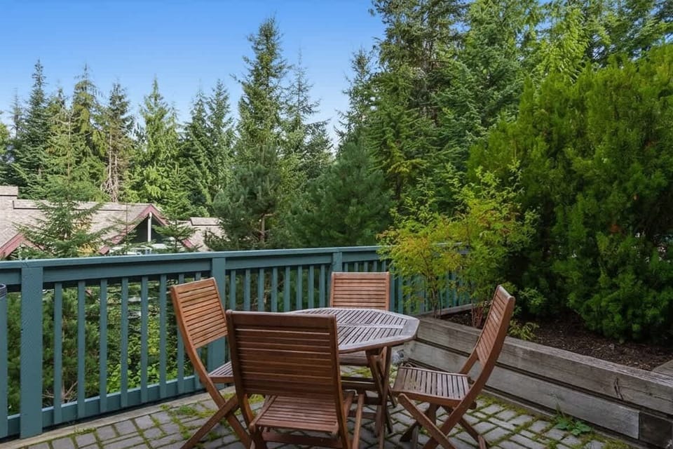 - Outdoor dining area on scenic deck with forest and mountain views  
- Enjoy morning coffee or evening meals in fresh Whistler air  
- Peaceful space surrounded by evergreens and mountain serenity  