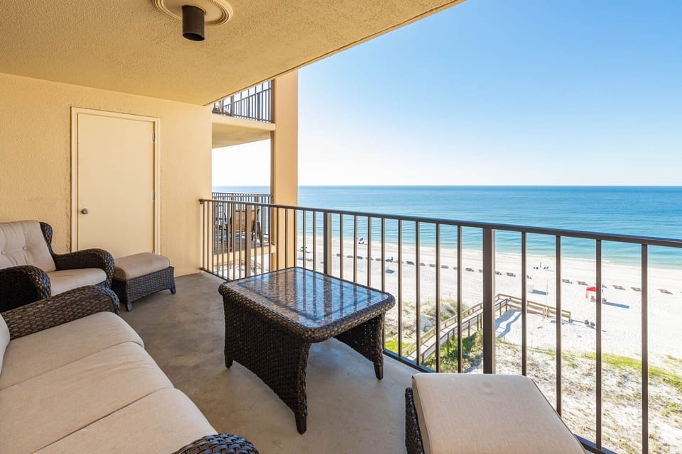 Relax on the balcony with comfortable seating and breathtaking views of the beach just steps away