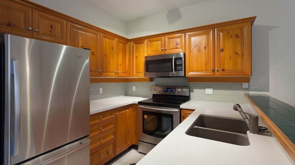 - Fully equipped Whistler kitchen with stainless steel appliances  
- Wooden cabinets add rustic charm and mountain-style warmth  
- Ideal for cooking family meals after outdoor adventures  