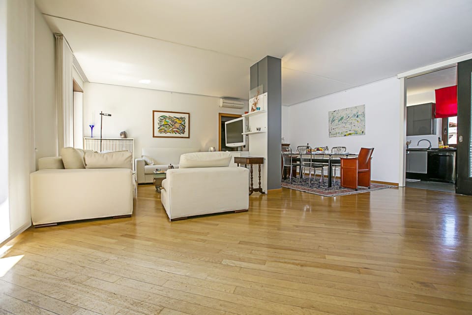 The spacious living room with view of the kitchen