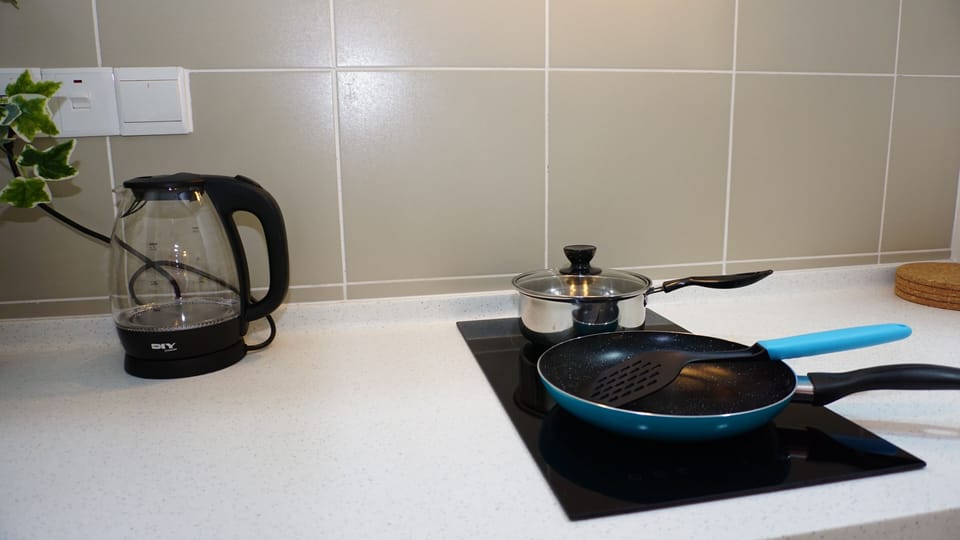 Kettle and cooking pots are provided.