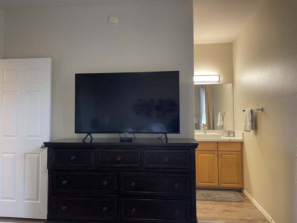 Dresser and 55' TV in master bedroom 2