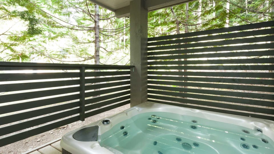 - Private hot tub surrounded by lush forest scenery  
- Ideal for relaxing after skiing or hiking trails  
- Peaceful spa-like comfort in mountain setting  