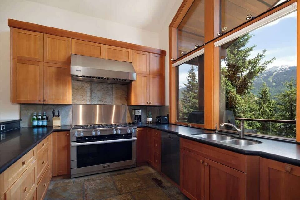 - Modern kitchen with mountain views and high-end stainless steel appliances  
- Wooden cabinetry blends rustic charm with clean, contemporary finishes  
- Perfect setup for cooking hearty meals after a day on the slopes  