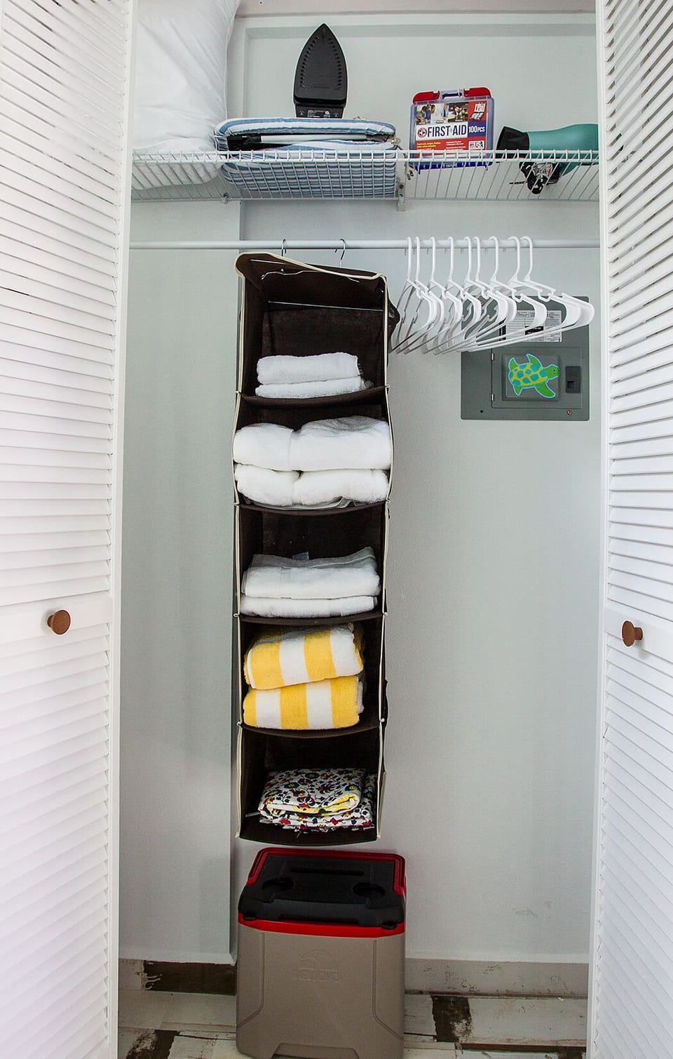 Cabinets stocked with beach gear and linens