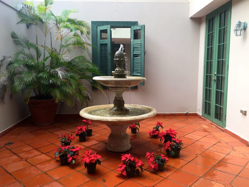 Villa Entryway with Spanish accents and  a courtyard with a lovely fountain 