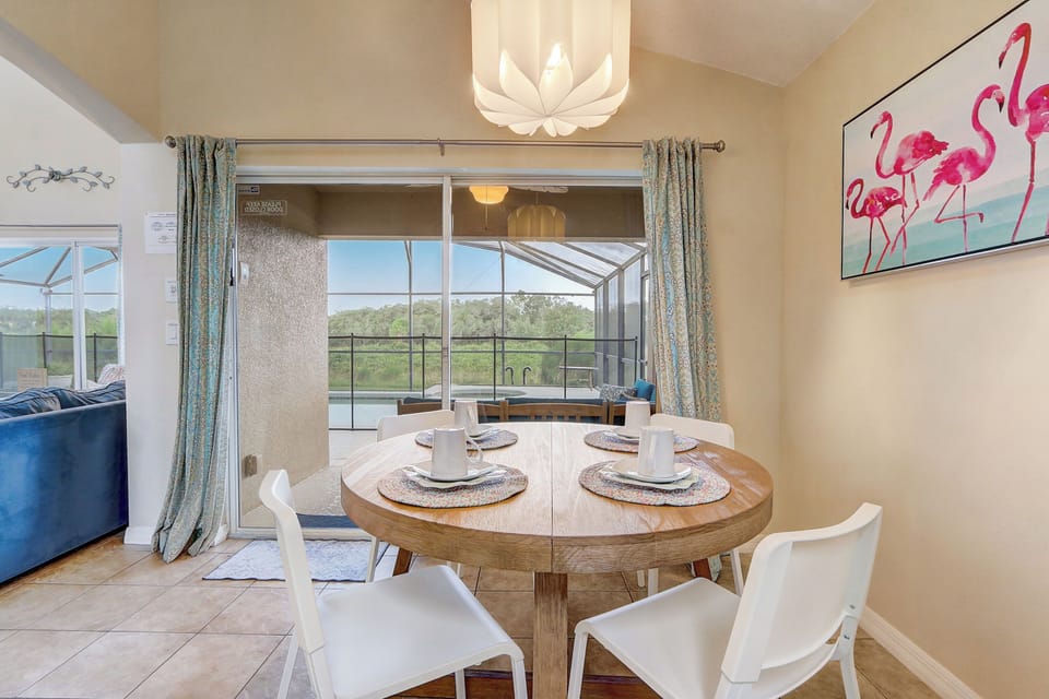 The kitchen table offers a lovely view of the Pool area and back yard.