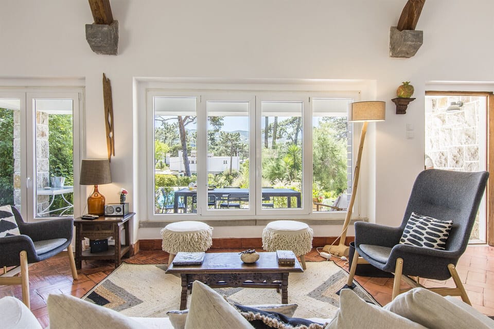 Bright living room with panoramic windows and mid-century chairs — Villa Blanche, holiday villa in Sintra