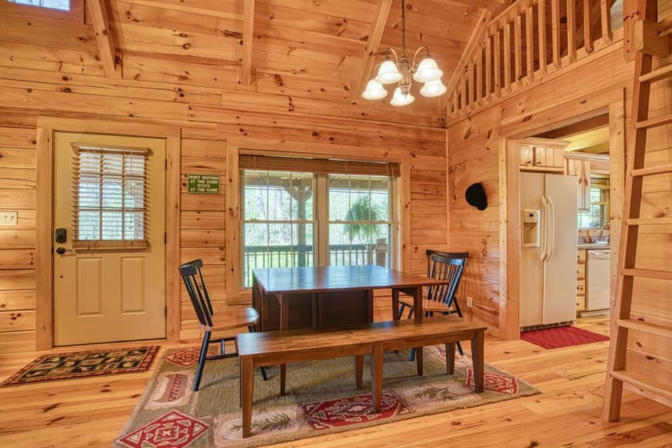Rustic dining area with wooden table and bench, perfect for cozy cabin meals.