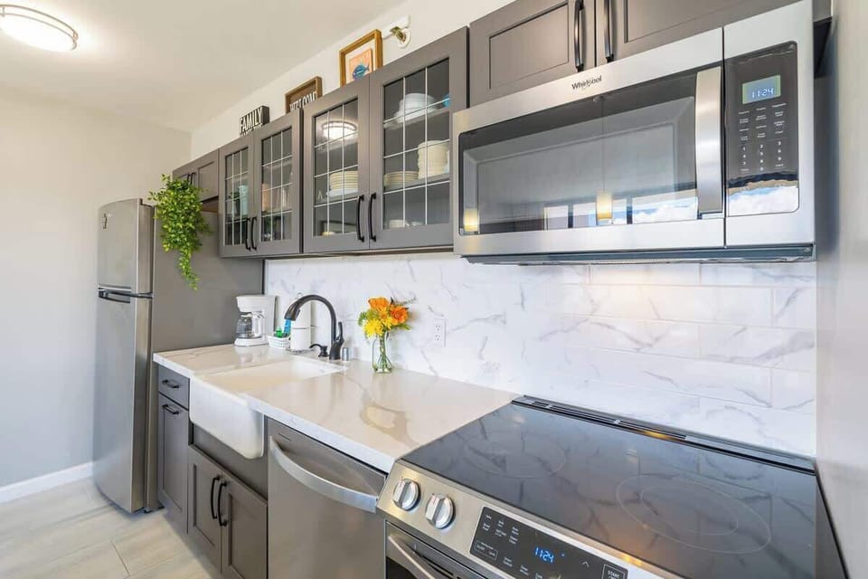 Modern kitchen with stainless steel appliances and glass-front cabinets