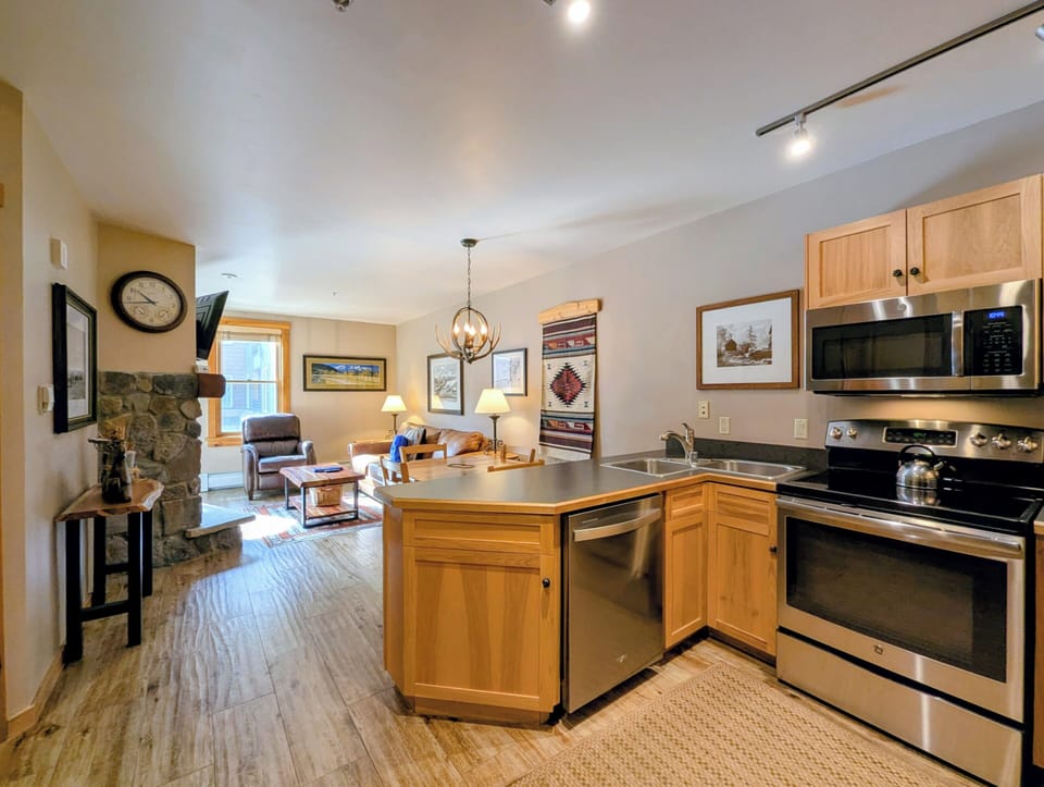 You'll love cooking in this fully equipped kitchen with stainless appliances, then relaxing by the stone fireplace in your cozy living space.