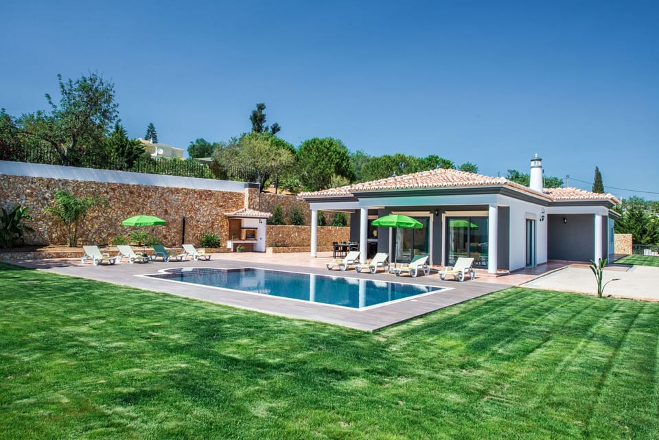 Outside area with large swimming pool and beautiful garden