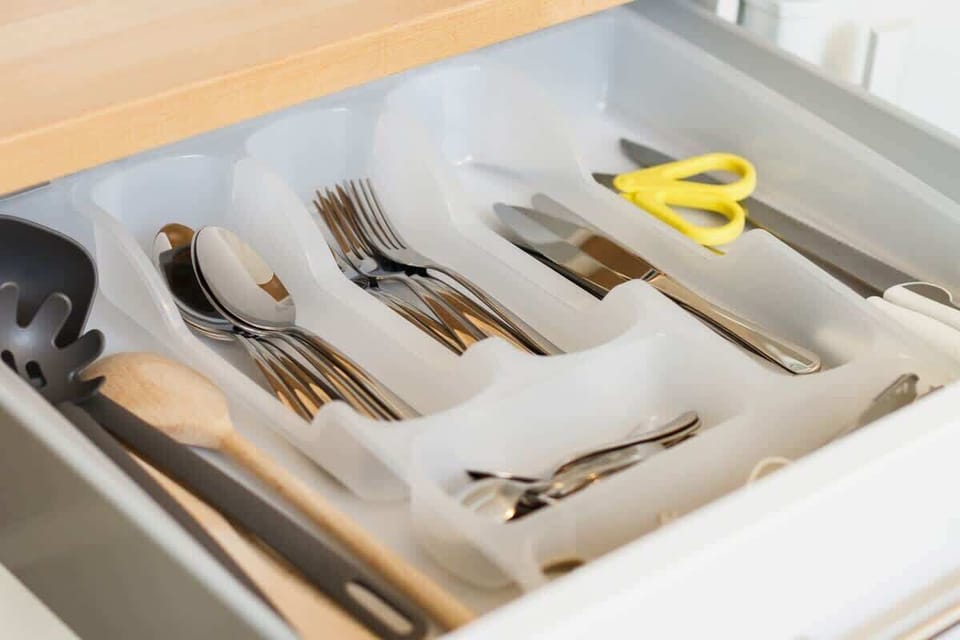 Close-up of a neatly organized kitchen drawer with cutlery and utensils.