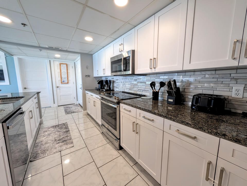 Sleek modern kitchen with granite counters and stainless steel appliances