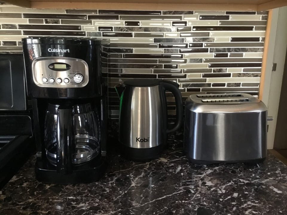 Cuisinart coffee pot, Kobe electric tea kettle, and Black & Decker toaster. 