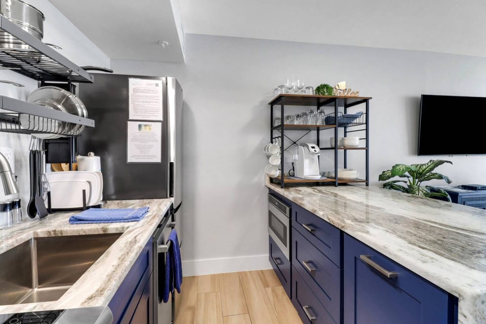 The open kitchen is beautifully remodeled, efficiently organized, and includes the basics needed to make meals easy and enjoyable.