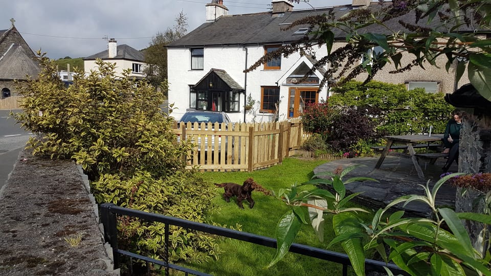 The fully enclosed dog friendly front garden and parking bay