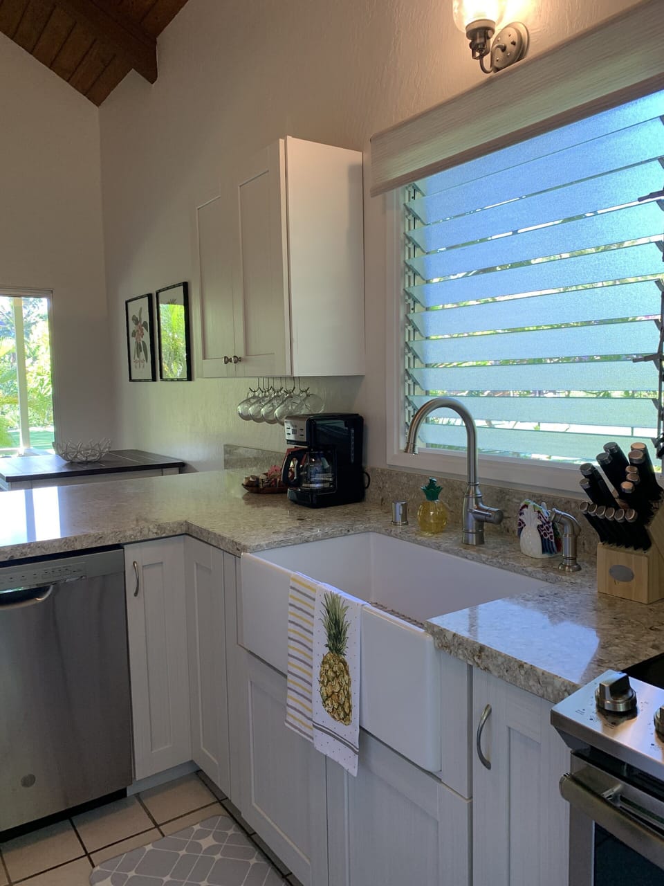 Enjoy views of the plumeria trees and tennis court from the farmhouse sink
