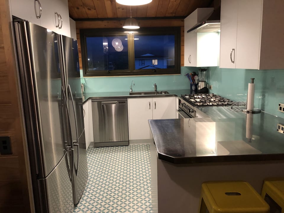 Kitchen: large double sink, 2 big fridges, 5 burner gas stove, oven, dishwasher 