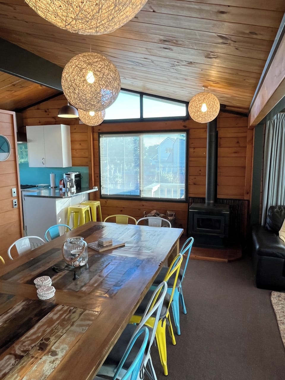 Living room showing dining table for 12; 3 sofas at right of picture.