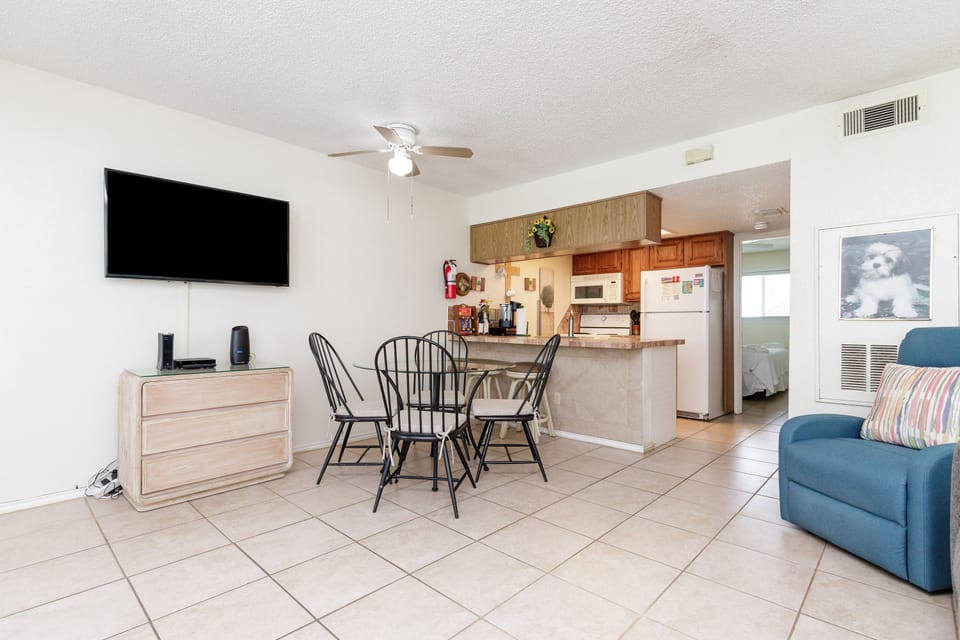 Your open-concept living space flows seamlessly from cozy seating to dining and kitchen, creating the perfect gathering spot for memorable meals together.