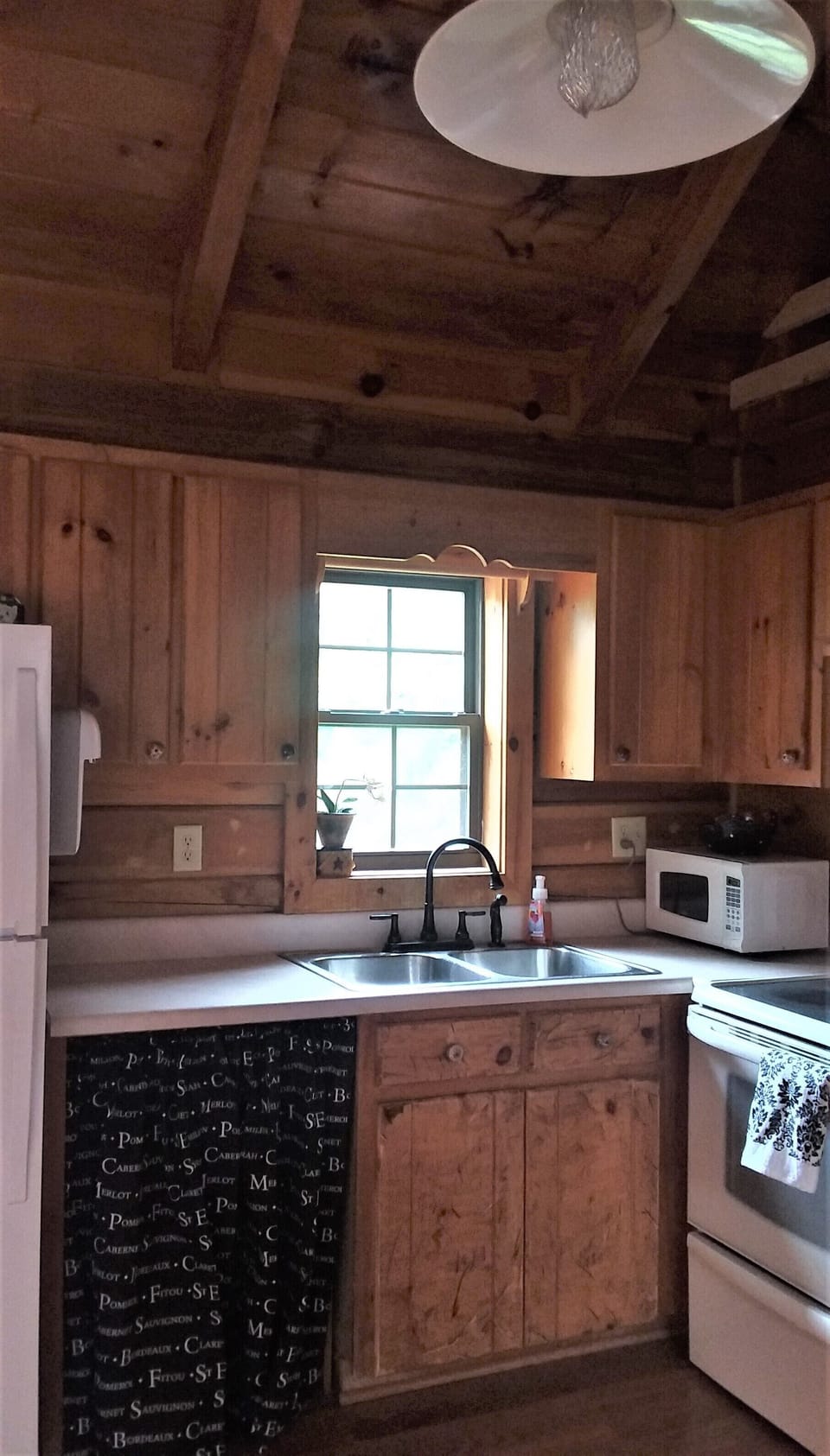 Kitchen is equipped with essential tools, coffee pot, kettle, etc.