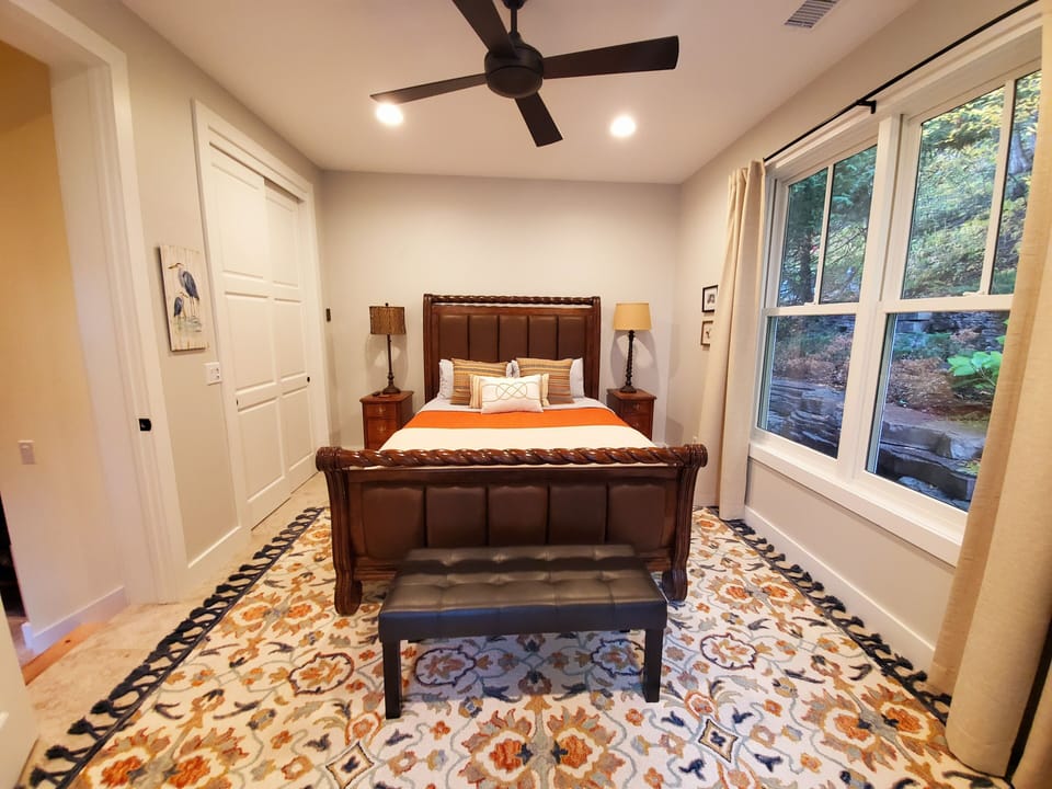 Guest Bedroom, main floor. Closet, built ins, heated floor, darkening drapes.  