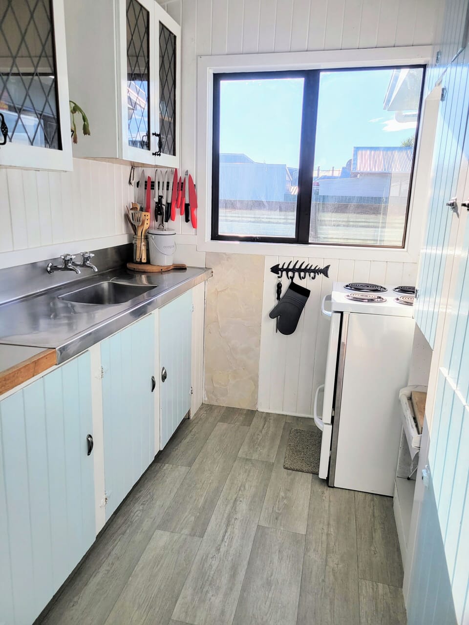 Original galley kitchen complete with oven, microwave and fridge/freezer. 