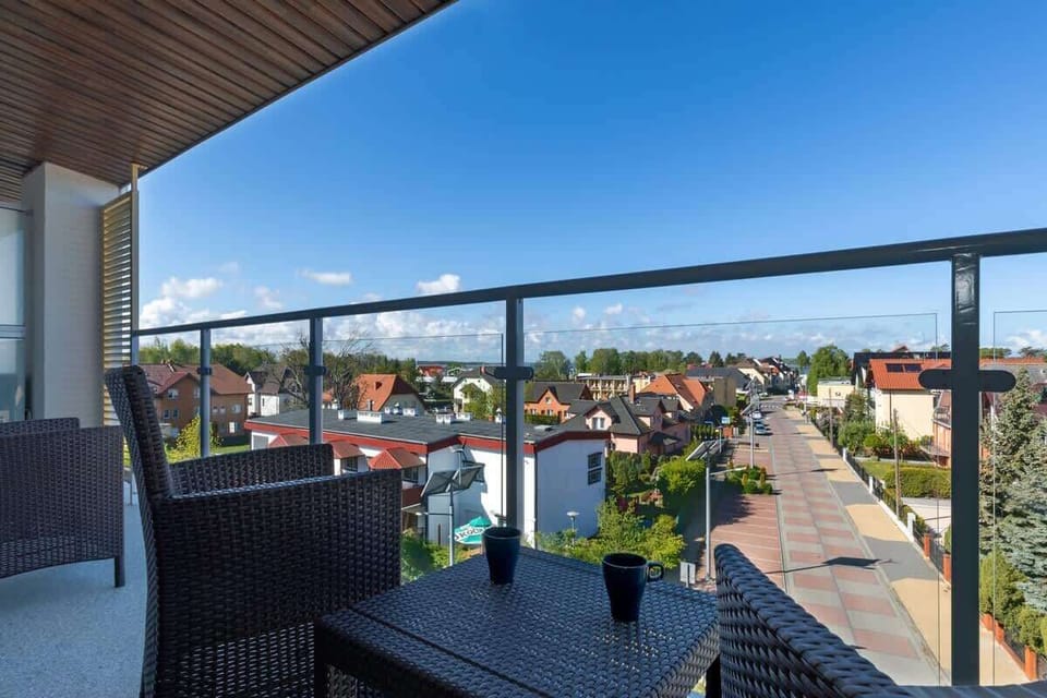 Furnished balcony with green surroundings. 