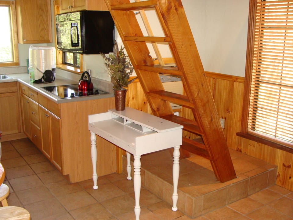 Stairway leads to loft with two small spaces with twin-sized beds.