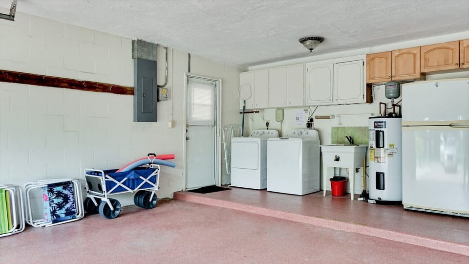Large, open garage with washer and dryer.