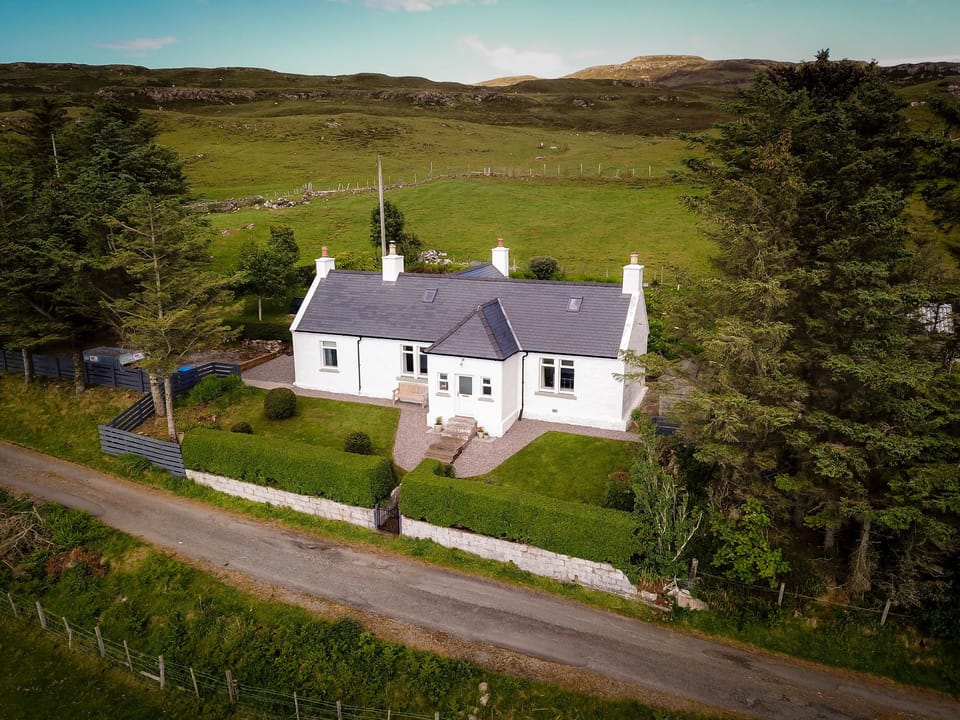 Traditional croft house sitting in elevated position overlooking Loch Snizort
