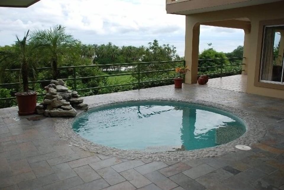 Pool with Ocean View and Waterfall Feature.  Enjoy after a stroll on the beach