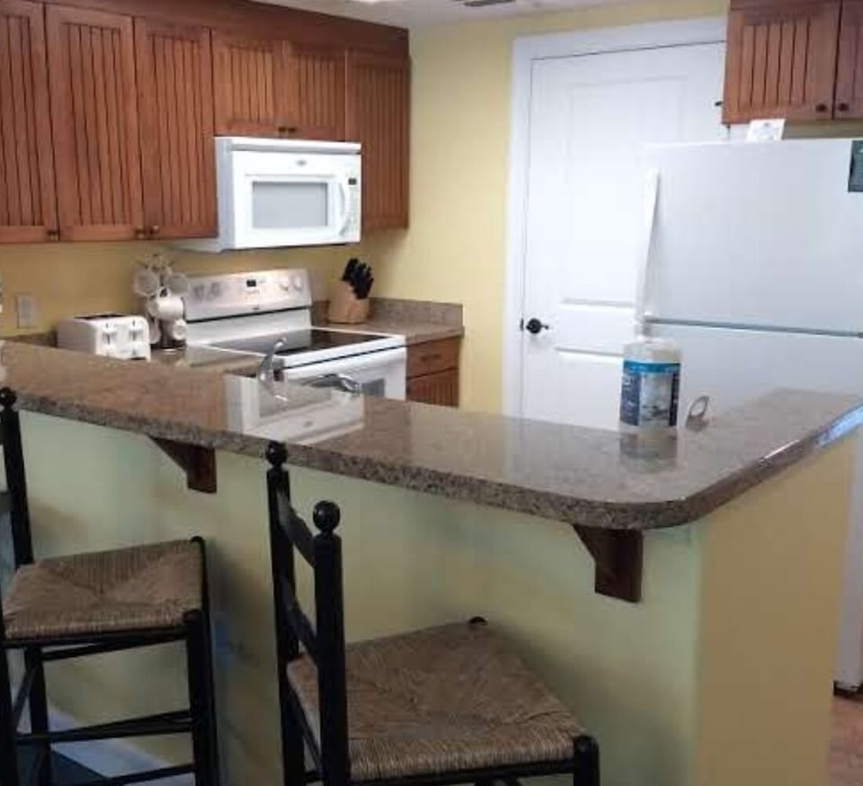 Fully Equipped Kitchen — Includes Dishes, Cutlery, Glasses, and Pots/Pans.