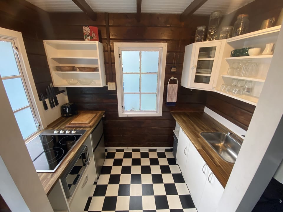 Kitchen with 4 burner hob, microwave, fridge, kettle, toaster & essentials